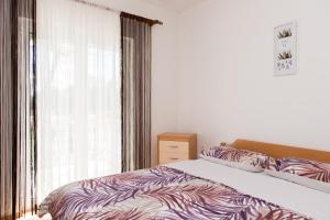 a bedroom with a bed and a window at Kuća za odmor - My Soul in Šibenik +54 photos