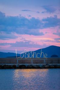 a wall with the word blizzard written on it next to the water at La Blanche Resort & Spa in Turgutreis