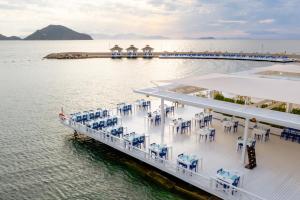 a cruise ship on the water with tables and chairs at La Blanche Resort & Spa in Turgutreis