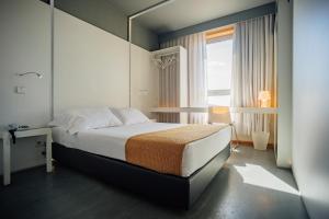 Postel nebo postele na pokoji v ubytování Basic Braga by Axis