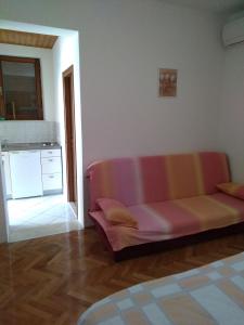 a living room with a couch and a kitchen at Apartman Larus in Starigrad-Paklenica