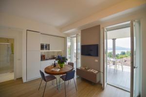 a kitchen and dining room with a table and chairs at The View in Baveno