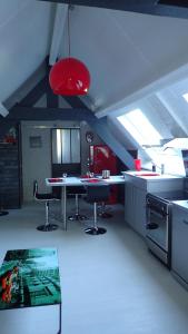 a kitchen with a table and chairs in a room at La louisiane in Montivilliers