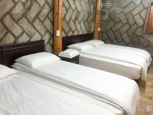 Katil atau katil-katil dalam bilik di Qin Bi Qingnian Homestay