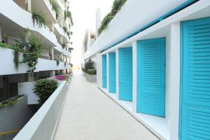 a row of blue shuttered windows on a building at Cimer SafraMarine Beach Resort in Safra