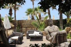 a statue of a man sitting in a chair at Europe Villa Cortes GL in Playa de las Americas