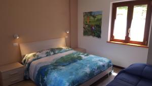 Postel nebo postele na pokoji v ubytování B&B Lo Slittone