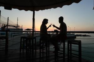 a man and woman sitting at a table drinking wine at Cimer SafraMarine Beach Resort in Safra