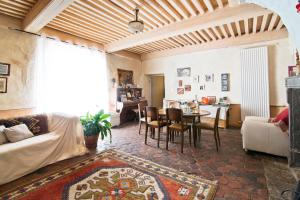 a living room with a couch and a table at La maison des archers in Saint-Saturnin