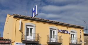 a yellow building with a hospital sign on top of it at Nuevo Hostal Paulino in Trujillo