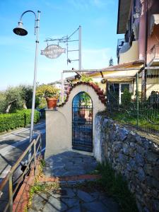 a gate to a house with a stone wall at Locanda Miranda in Tellaro
