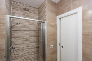 a shower with a glass door in a bathroom at Fumiko in Sanlúcar de Barrameda +36 photos