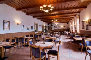 a restaurant with tables and chairs in a room at Hotel Avion in Prague