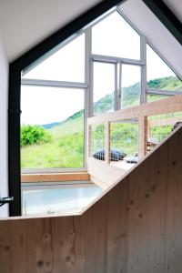 a room with a large window in a house at Premium Design Ferienhäuser Mosel Chalets in Pommern
