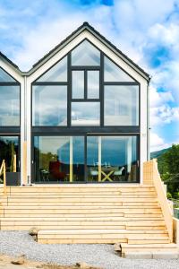 a house with large windows and a table on a deck at Premium Design Ferienhäuser Mosel Chalets in Pommern