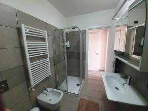 a bathroom with a sink and a shower and a toilet at Residence La Margherita in Lazise