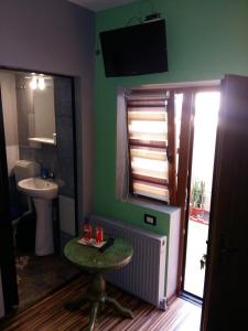 a bathroom with a sink and a toilet and a mirror at Sea Side in Constanţa