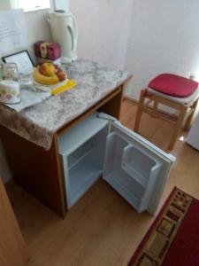 a kitchen with a counter with a small refrigerator at Room Center Old Town in Dubrovnik