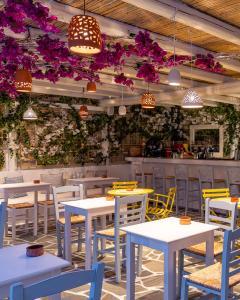 a dining area with tables and chairs at Airotel Alexandros in Athens