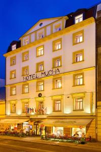 a hotel with a sign on the front of it at Hotel Mucha in Prague