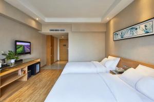 Postel nebo postele na pokoji v ubytování Insail Hotels Railway Station Guangzhou