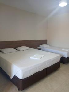 Giường trong phòng chung tại Hotel HOSPEDA Marília