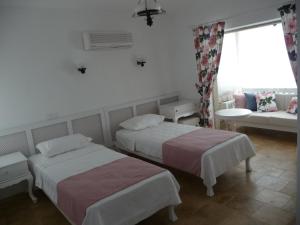 Postel nebo postele na pokoji v ubytování Yelken Konak Alacati