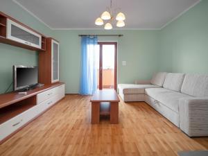 a living room with a white couch and a tv at Holiday Home Mario 1 by Interhome in Hreljići