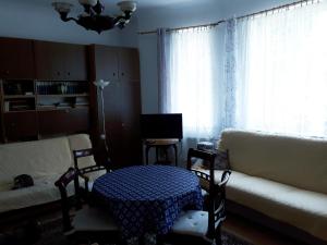 a living room with a table and a couch at Apartament u Barbary in Wisełka