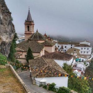 a group of buildings with a tower and a town at Las Casitas de la Esquina in Zahara de la Sierra +25 photos