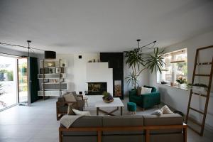 a living room with a couch and a fireplace at Siedlisko Vincent in Szydłów