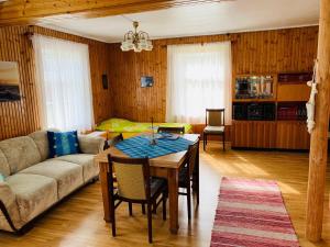 a living room with a table and a couch at Treimani Country House in Treimani