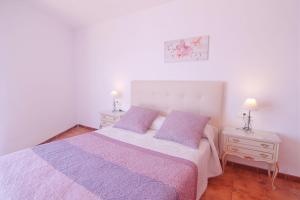 a bedroom with a large bed and two night stands at Caribe in Calpe