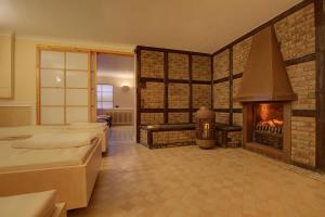 a room with a fireplace and a room with beds at Abaluga 4A in Wenningstedt