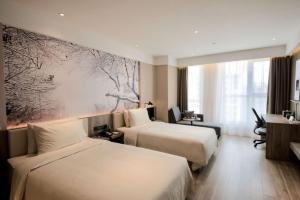 a hotel room with two beds and a large window at Atour Hotel Phoenix Avenue Shangrao in Shangrao
