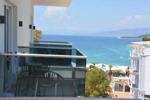 a balcony with two chairs and a view of the ocean at Summer Gate Hotel in Ksamil