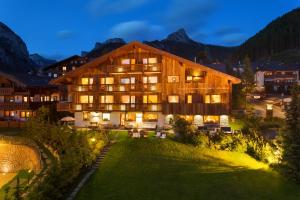 a hotel in the mountains at night at Mountain Home Villa Anna in Selva di Val Gardena