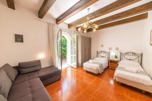 a living room with a couch and two beds at Appartamenti Ischia la Sentinella in Ischia