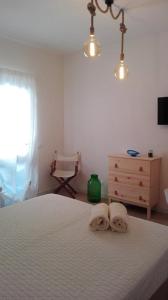 a bedroom with a bed with two towels on it at Il Viaggiatore in Marettimo