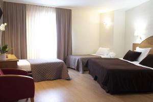 En eller flere senge i et værelse på Hotel Maruxia *** Superior