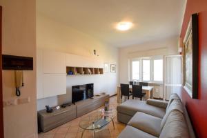 a living room with a couch and a television and a table at Castagnola 8 in Verbania