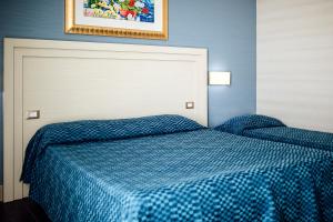 Postel nebo postele na pokoji v ubytování Hotel Palazzo Giancola