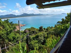 a view of the ocean from a lookout in the jungle at Hostel do Morro in Florianópolis