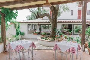 a patio with tables and chairs in a courtyard at Hotel Santa Rosalia in Marina di Camerota