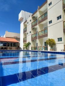 a large swimming pool in front of a building at Hotel Costa do Delta in Tutóia