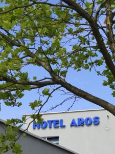 a sign on the top of a hotel apolis building at Hotel Aros in Tychy