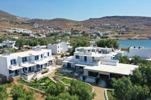 an aerial view of a large white house at Nostos Beachfront Apartments & Studios in Agios Ioannis Tinos