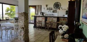 a dining room with a table and a clock on the wall at Villa Polercia in Cupello