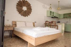 a bedroom with a bed with white sheets and a mirror at PanMari in Paphos