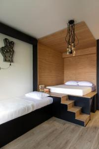 two beds in a room with a staircase between them at Bespoke House Athens in Athens